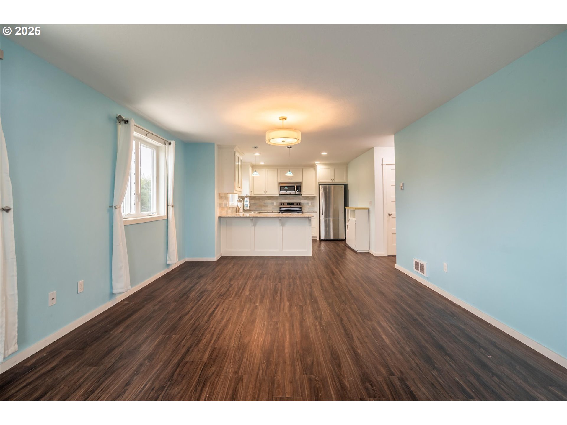 3145 Periwinkle Lane Southwest Bandon, OR 97411 - Photo 9 of 26 a view of a kitchen with a sink and a refrigerator
