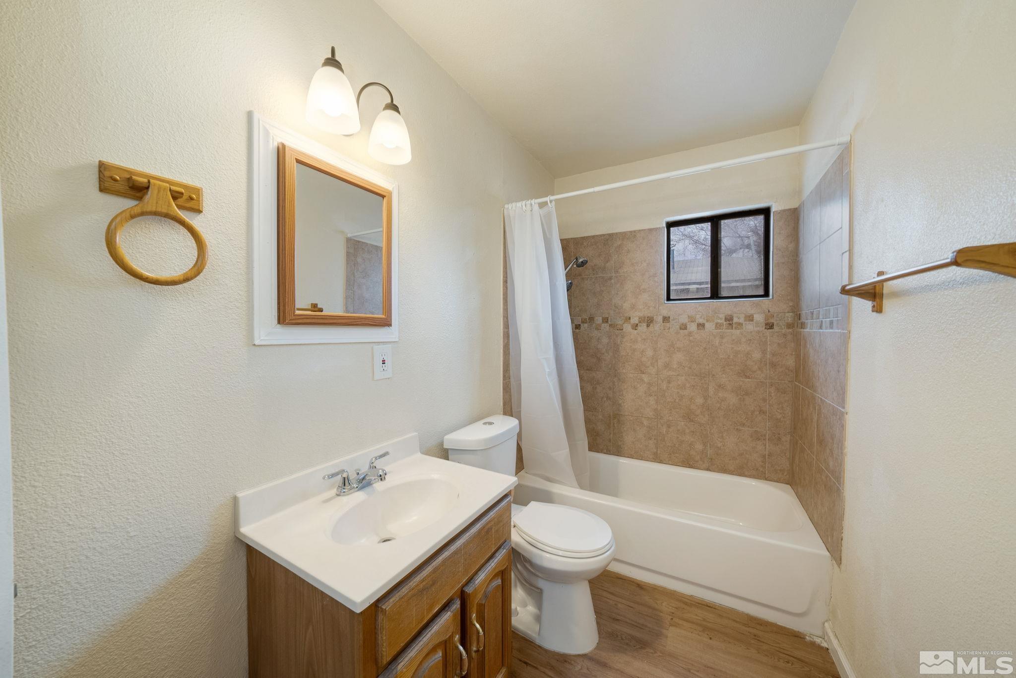 1680 Sterling Way Reno, NV 89512 - Photo 13 of 20 a bathroom with a toilet sink and mirror