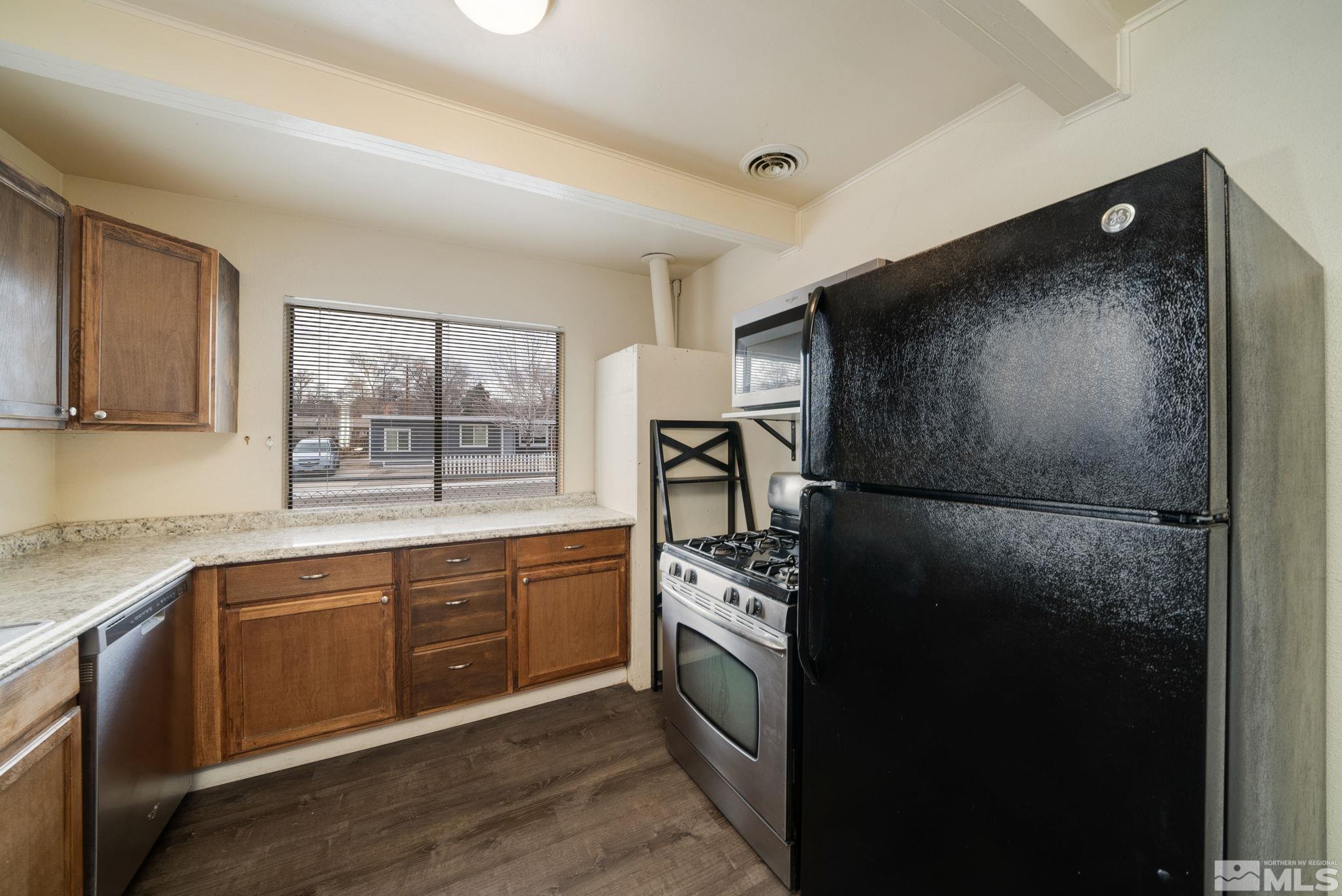 1680 Sterling Way Reno, NV 89512 - Photo 6 of 20 a kitchen with a refrigerator and a sink