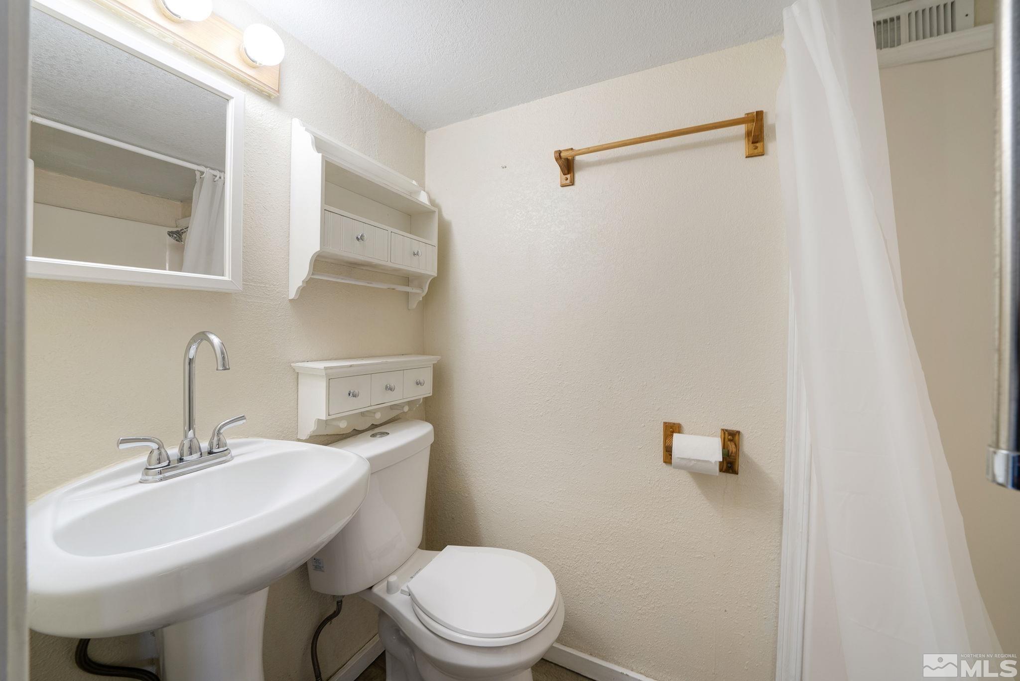 1680 Sterling Way Reno, NV 89512 - Photo 9 of 20 a bathroom with a sink toilet and a mirror