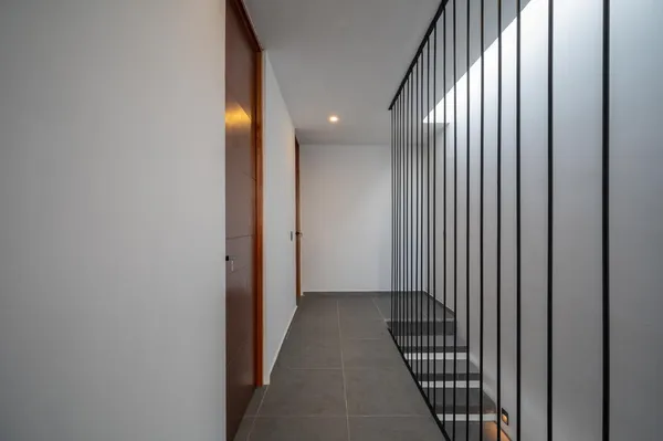 a view of a hallway with wooden floor