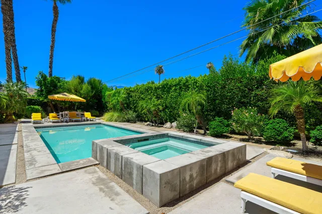 a view of a swimming pool with a lounge chairs
