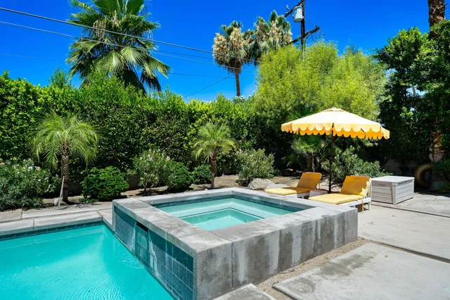 a view of a swimming pool with lounge chairs