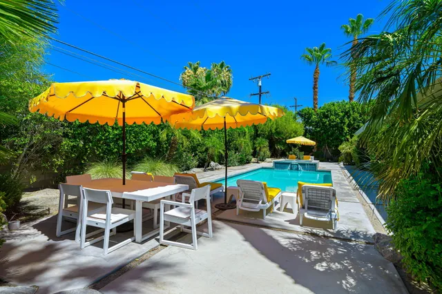 a view of a house with swimming pool and sitting area