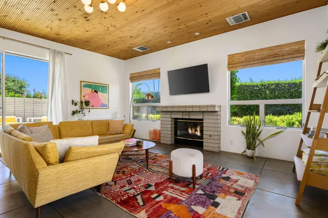a living room with furniture a rug and a fireplace