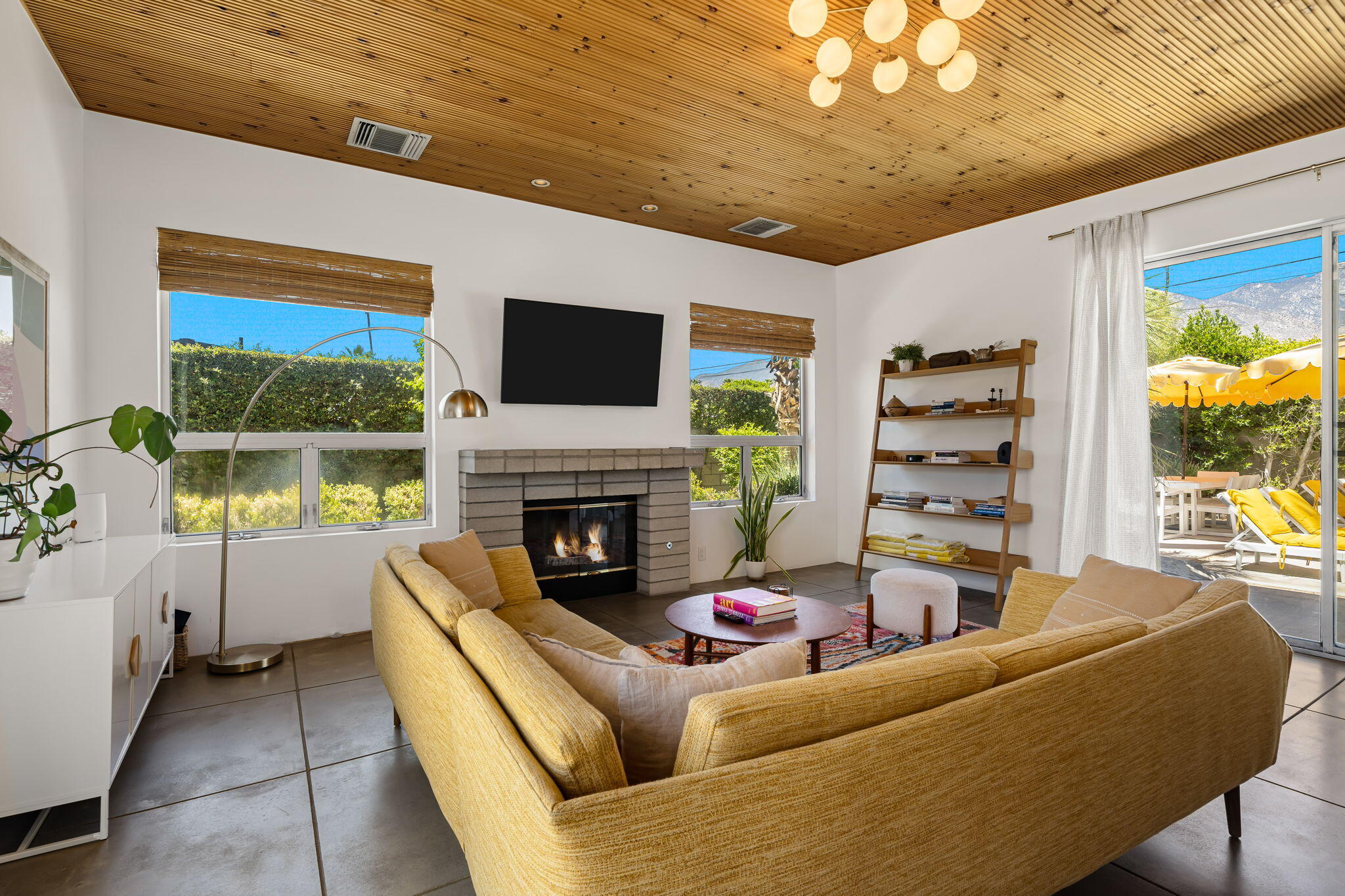 623 Desert Way Palm Springs, CA 92264 - Photo 6 of 39 a living room with furniture a flat screen tv and a fireplace
