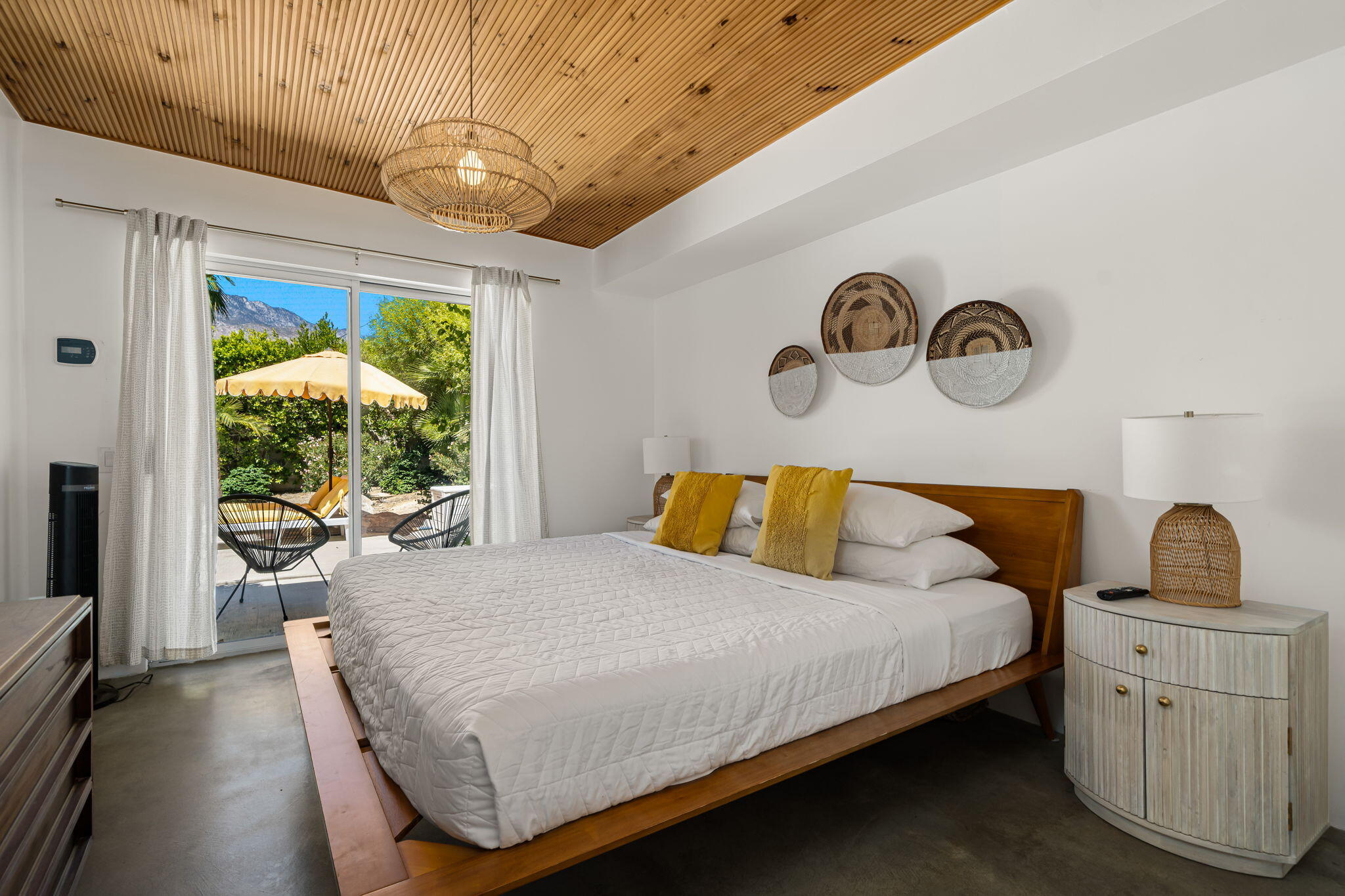 623 Desert Way Palm Springs, CA 92264 - Photo 9 of 39 a bedroom with a bed and a dresser next to a window