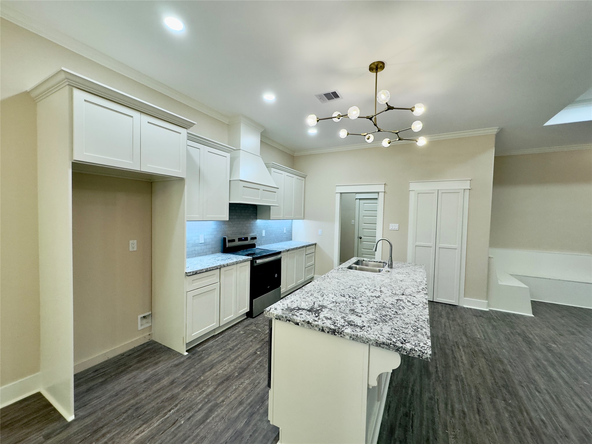 10730 Vinson Street Beaumont, TX 77713 - Photo 6 of 15 a kitchen with kitchen island granite countertop wooden floor and a refrigerator