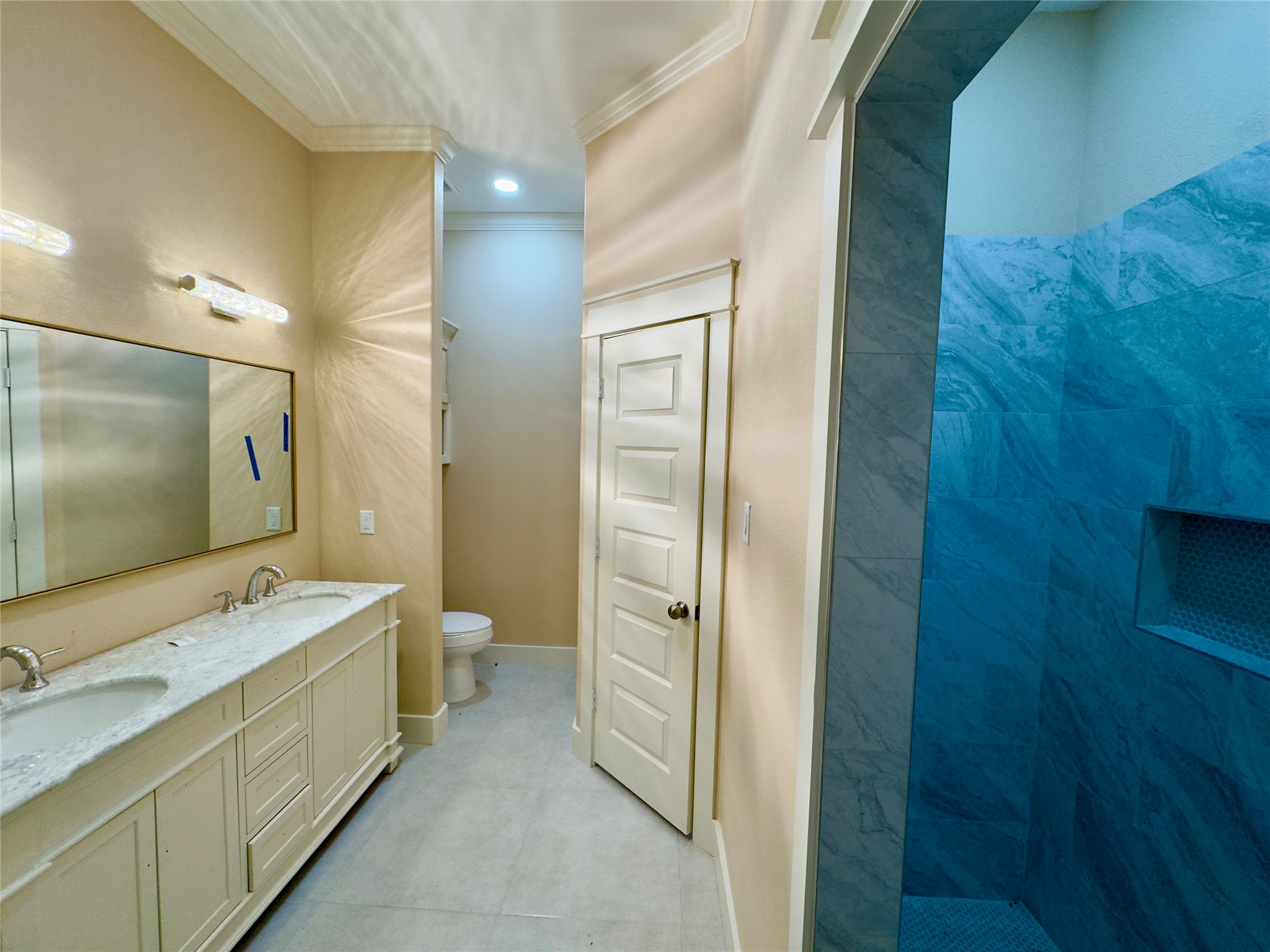 10730 Vinson Street Beaumont, TX 77713 - Photo 10 of 15 a bathroom with a double vanity sink and mirror with shower
