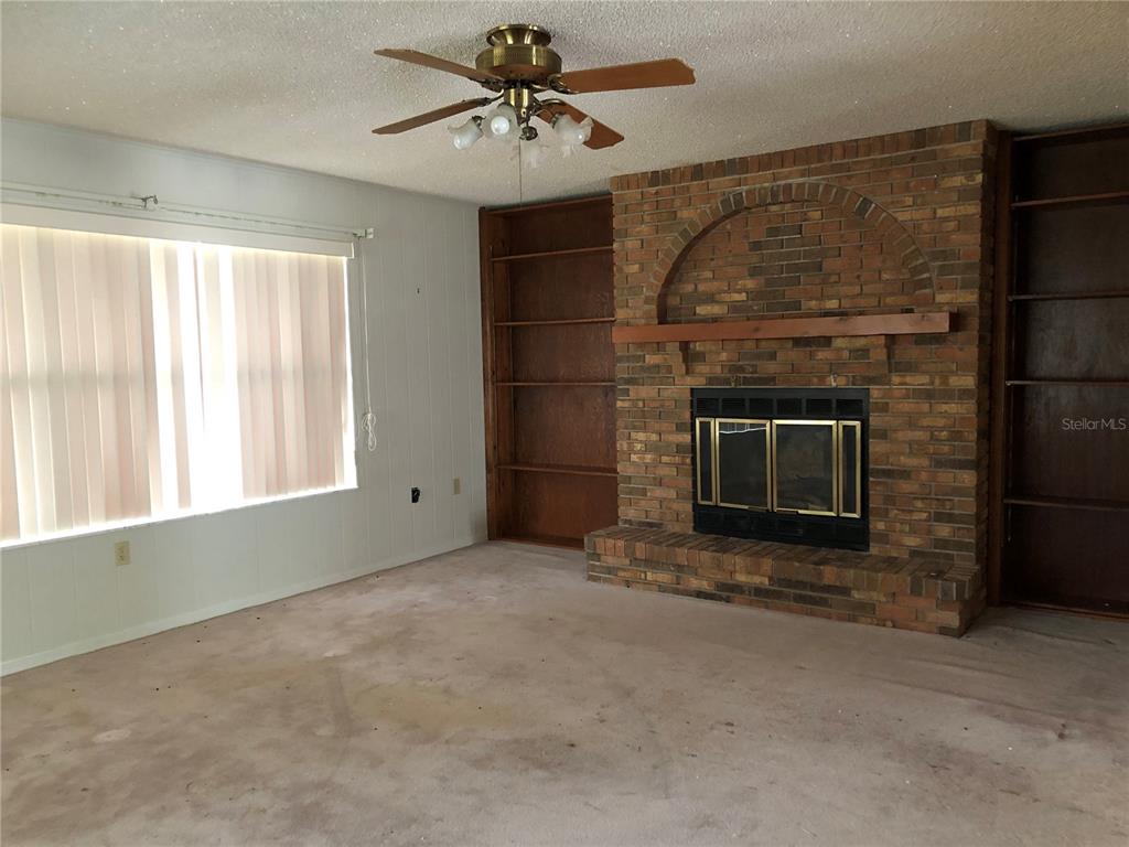 34847 Learn Road Leesburg, FL 34788 - Photo 34 of 42 a living room with a fireplace in it