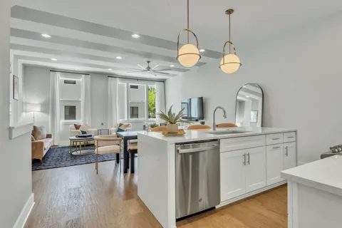 a bathroom with a toilet sink vanity and mirror