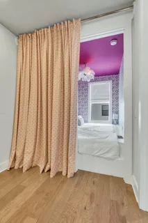 a bedroom with a bed and a wall painting