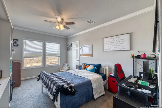 a bedroom with bed and a chandelier