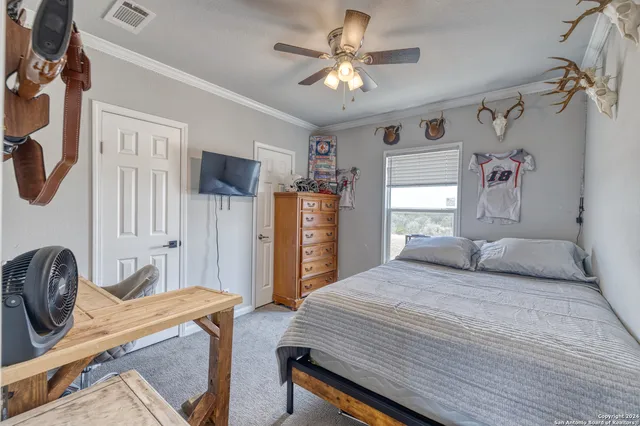 a bedroom with a bed dresser and a window