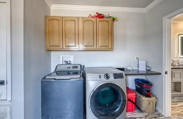 a utility room with sink dryer and washer