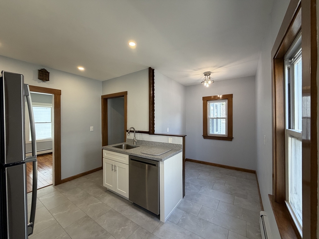 117 Merrymount Road, Unit 1 Quincy, MA 02169 - Photo 4 of 12 a view of a kitchen cabinets and a wooden floor