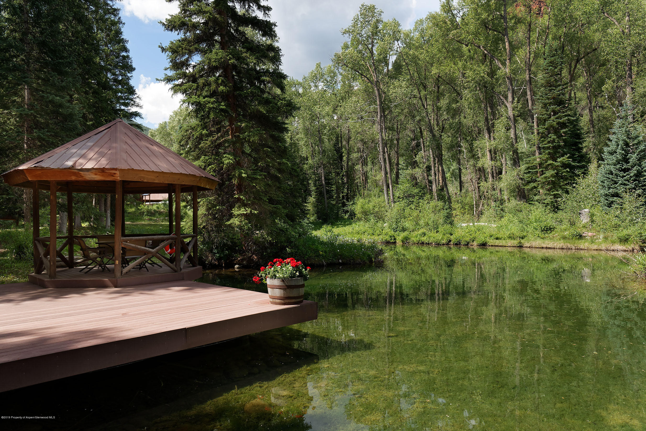 245-289 Conundrum Creek Road Aspen, CO 81611 - Photo 15 of 28 a view of house with swimming pool and outdoor seating
