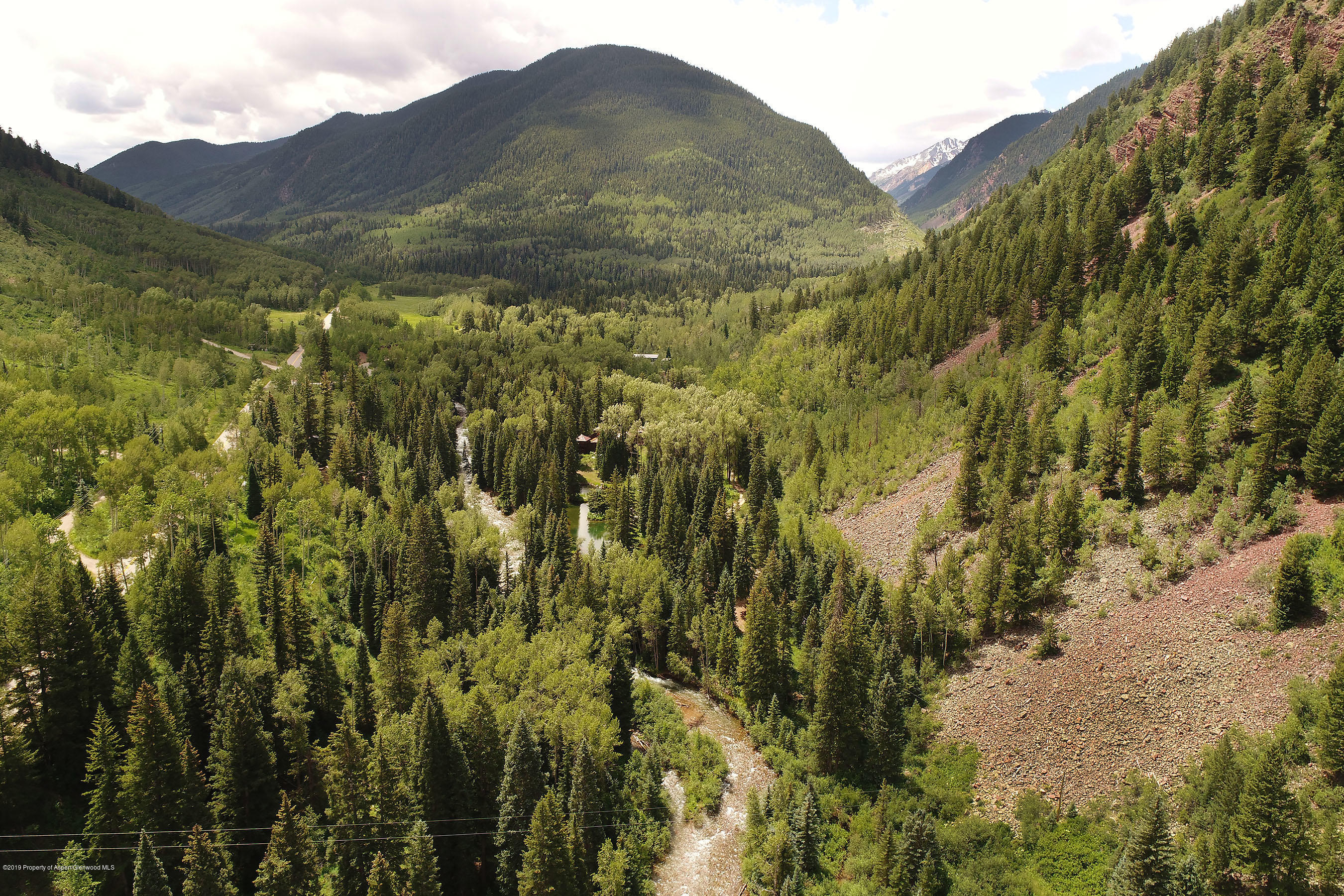 245-289 Conundrum Creek Road Aspen, CO 81611 - Photo 25 of 28 a view of a lush green hillside and a building