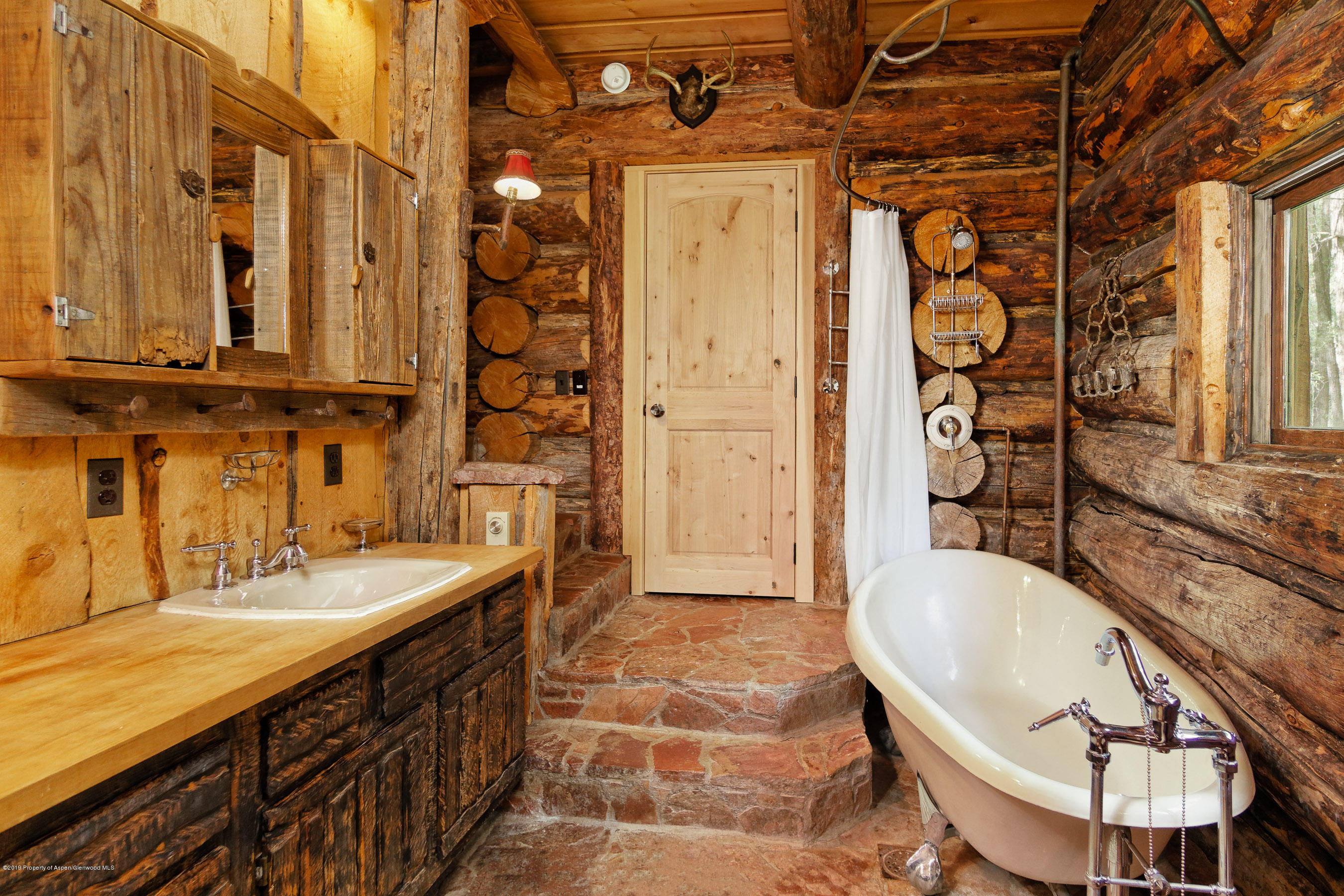 245-289 Conundrum Creek Road Aspen, CO 81611 - Photo 6 of 28 a bathroom with a tub sink and mirror