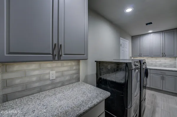a kitchen with granite countertop cabinets and steel stainless steel appliances