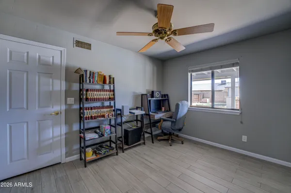 a view of a workspace with furniture and a window
