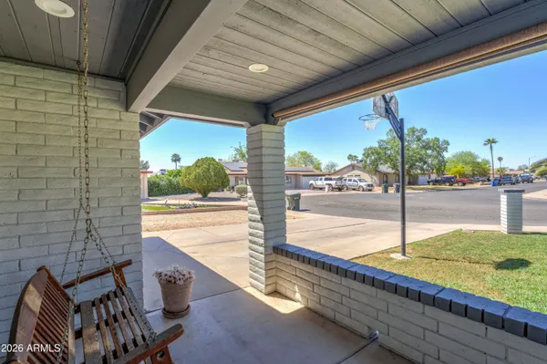 a view of a balcony with yard