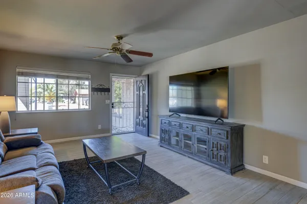a living room with furniture and a flat screen tv