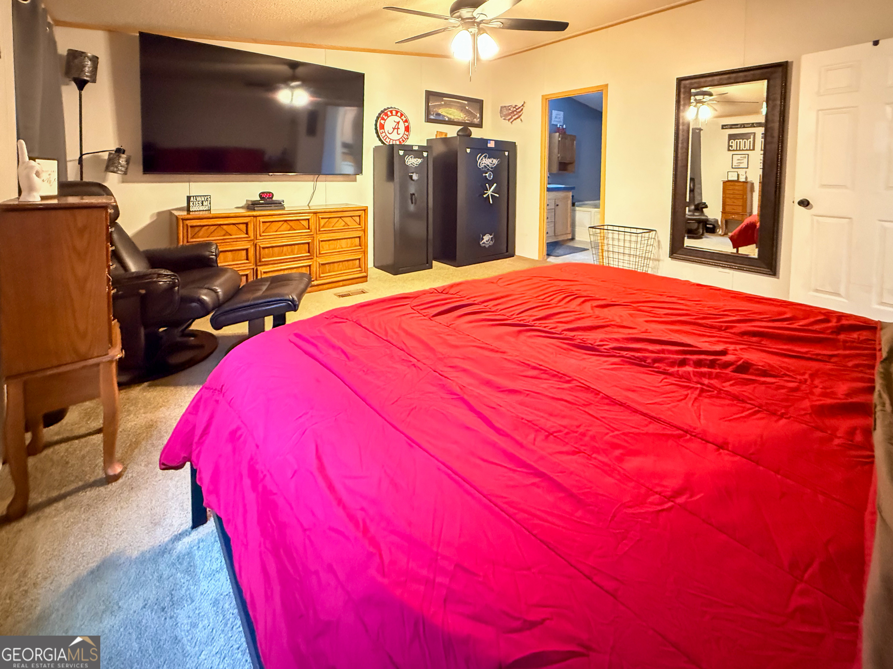 551 Hester Road Dahlonega, GA 30533 - Photo 14 of 35 a bed room with a bed and a flat screen tv