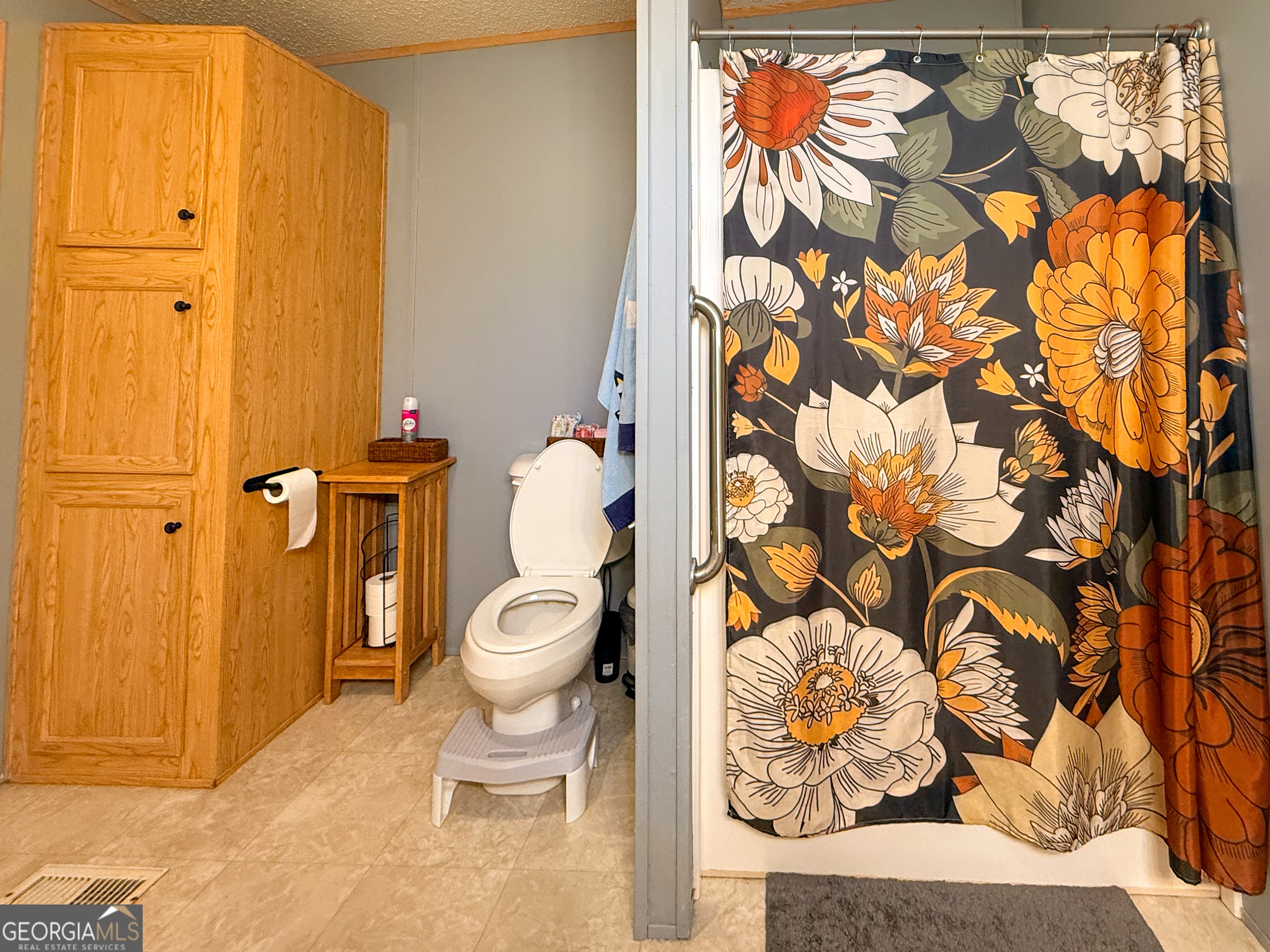 551 Hester Road Dahlonega, GA 30533 - Photo 16 of 35 a white toilet sitting next to a shower curtain