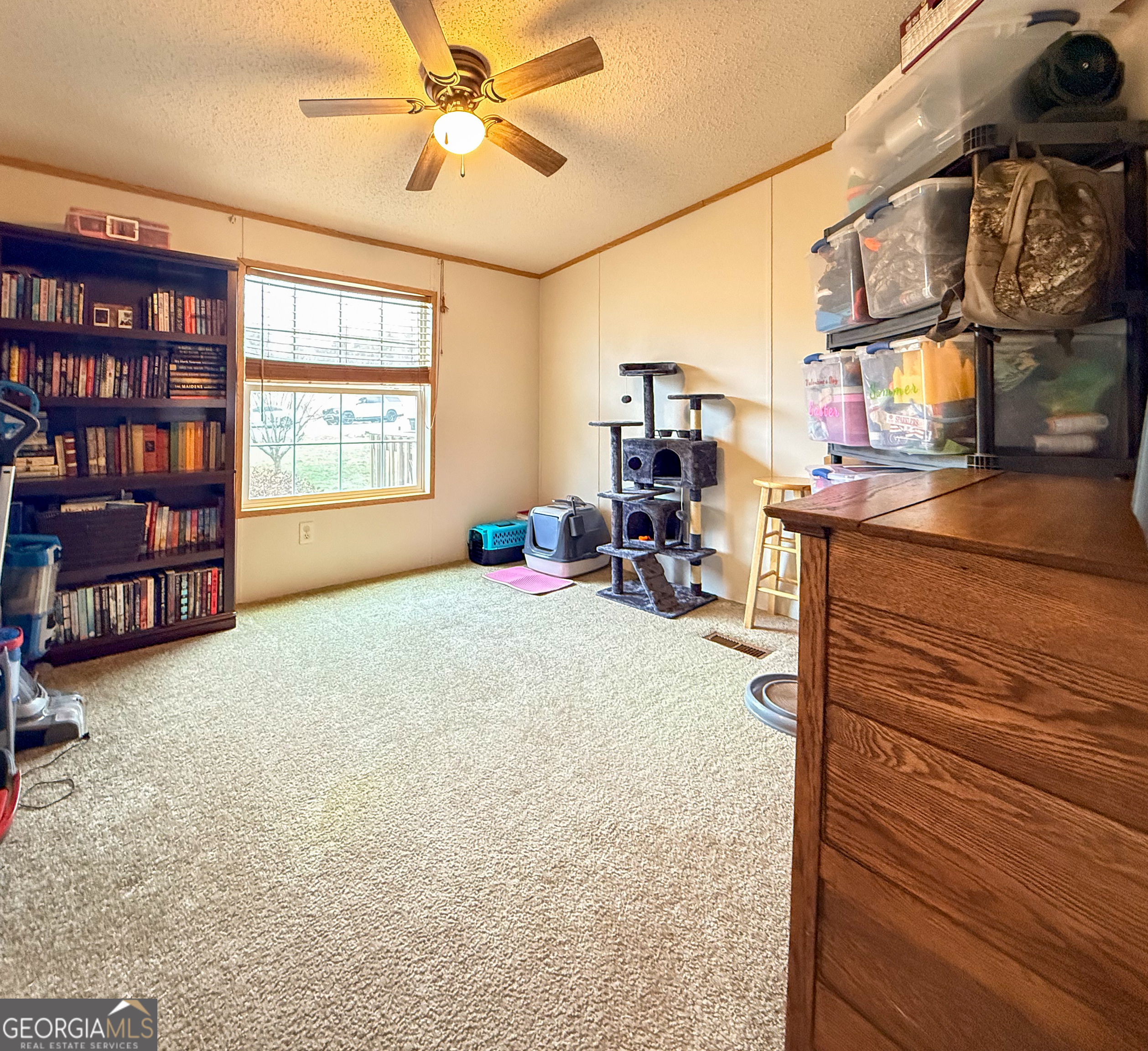 551 Hester Road Dahlonega, GA 30533 - Photo 18 of 35 a bed room with a bed and a book shelf