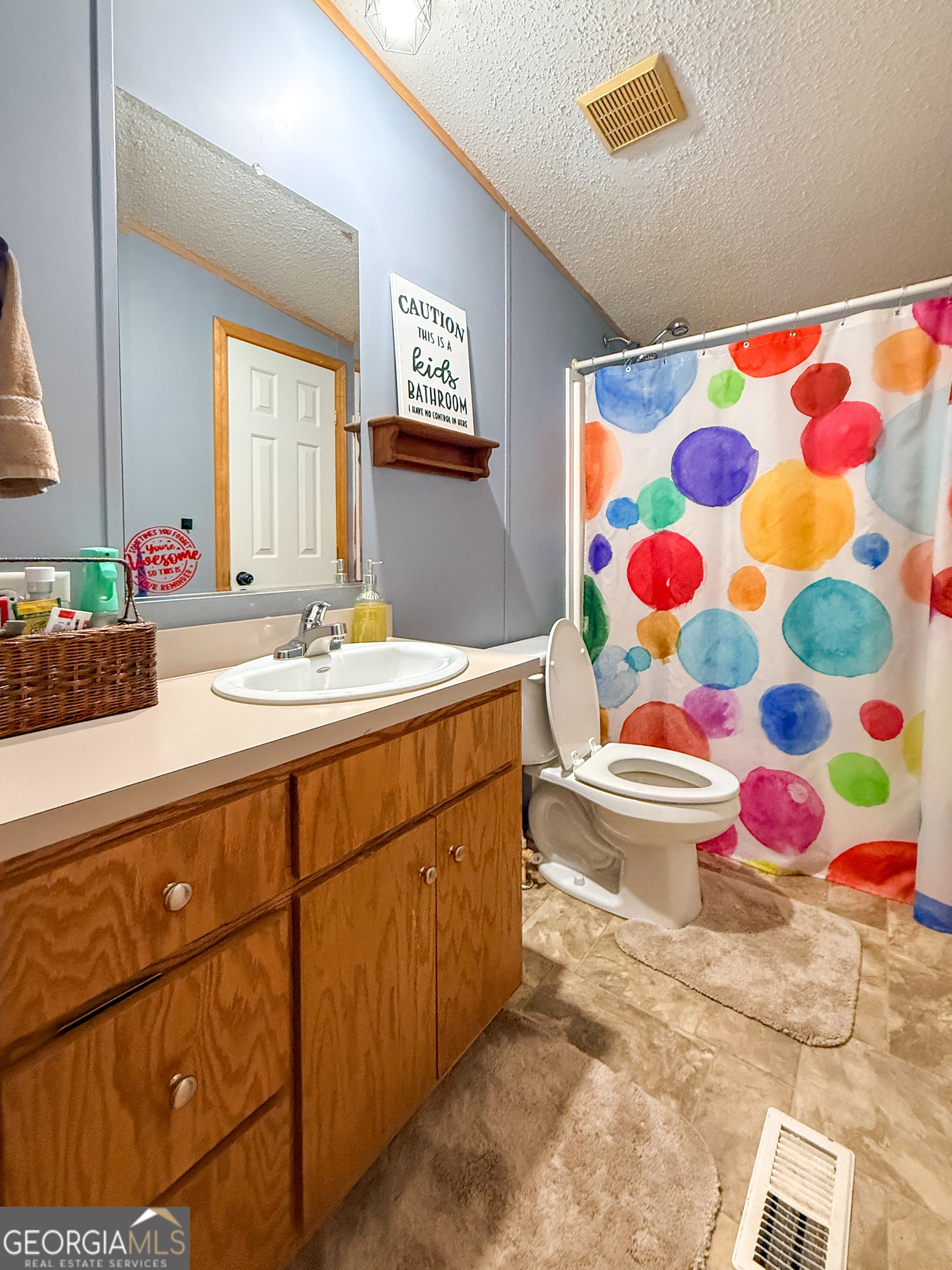 551 Hester Road Dahlonega, GA 30533 - Photo 23 of 35 a bathroom with a sink toilet and shower