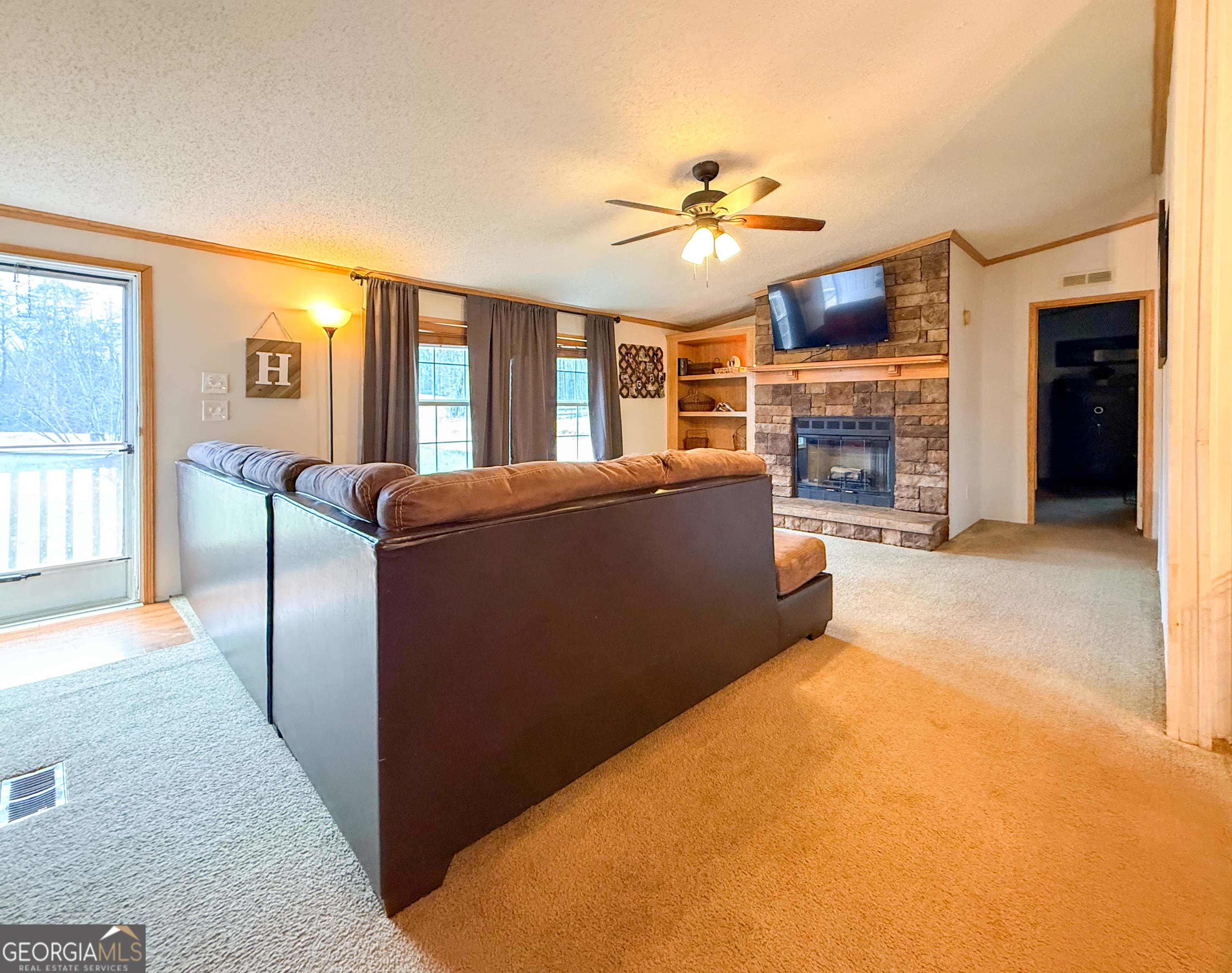 551 Hester Road Dahlonega, GA 30533 - Photo 4 of 35 a view of an empty room with window and fireplace