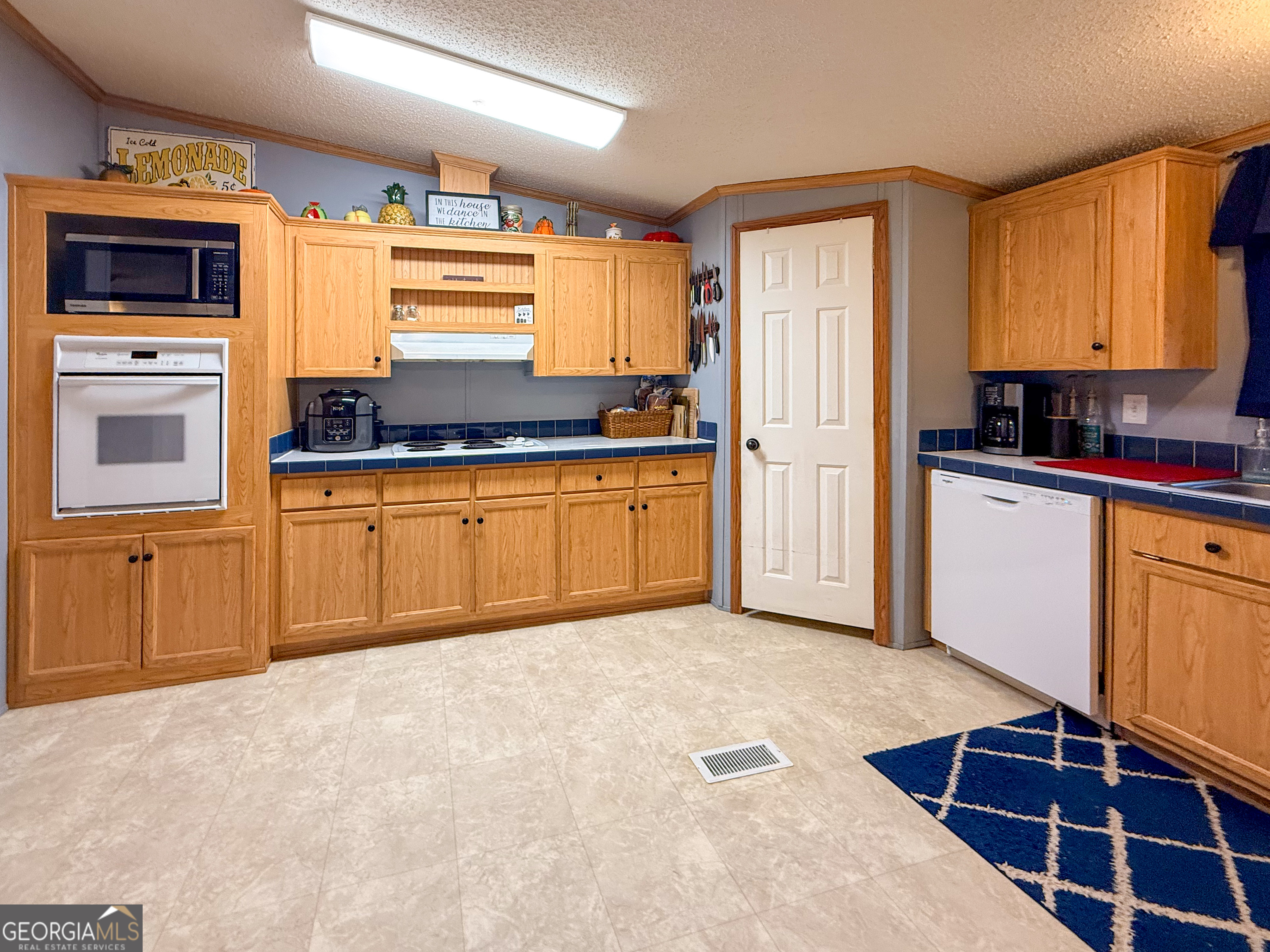 551 Hester Road Dahlonega, GA 30533 - Photo 8 of 35 a kitchen with stainless steel appliances granite countertop a stove top oven a sink and a refrigerator
