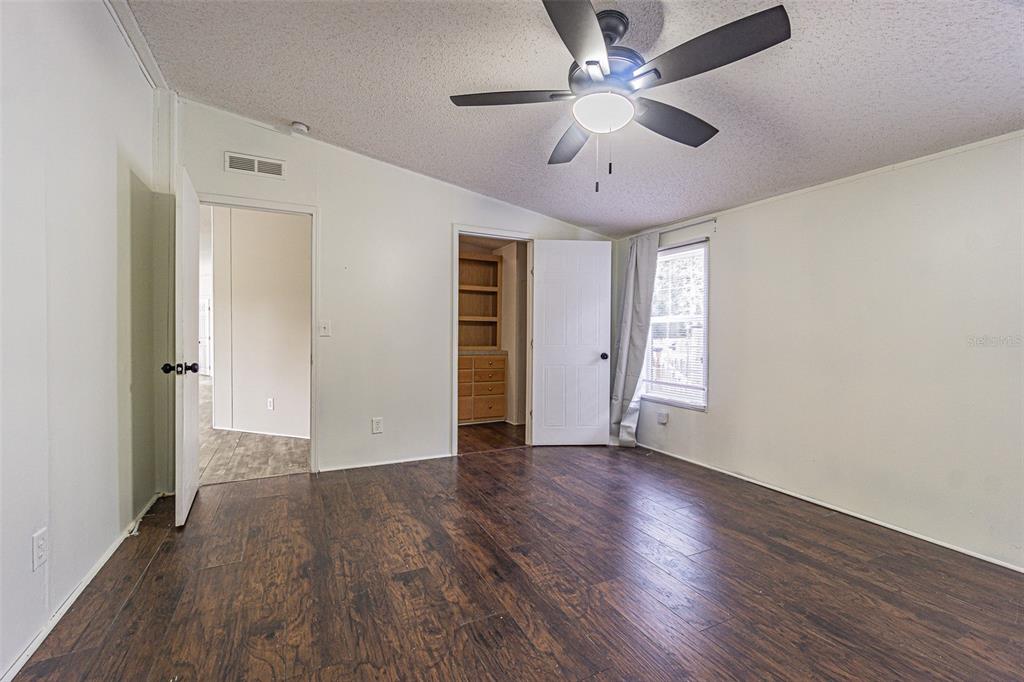 7029 Forbes Road Zephyrhills, FL 33540 - Photo 22 of 53 wooden floor in an empty room with a window