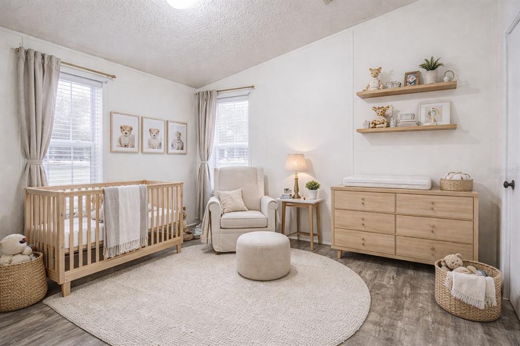 7029 Forbes Road Zephyrhills, FL 33540 - Photo 28 of 53 a bedroom with a bed and a window