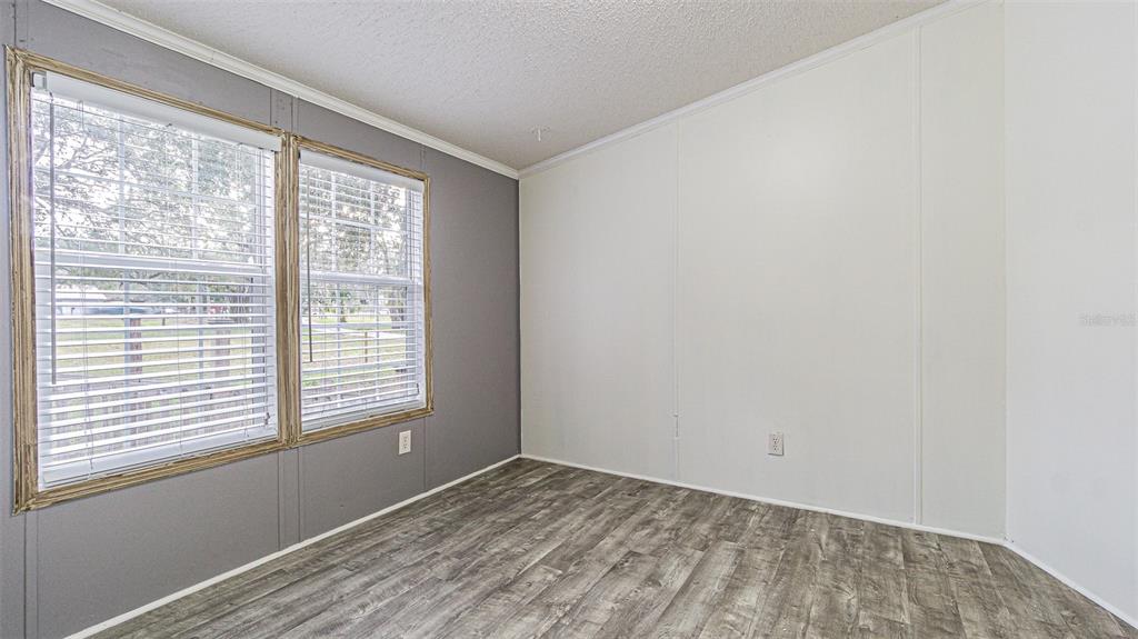 7029 Forbes Road Zephyrhills, FL 33540 - Photo 32 of 53 a view of an empty room with a window