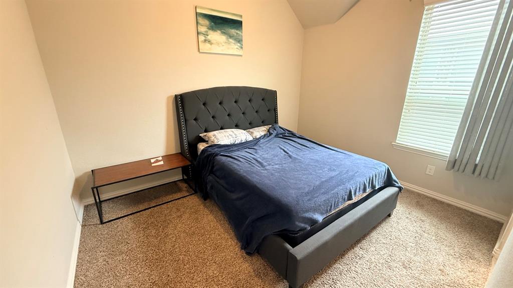 337 Prairie Ridge Lane Lewisville, TX 75056 - Photo 18 of 28 a bedroom with a bed and window