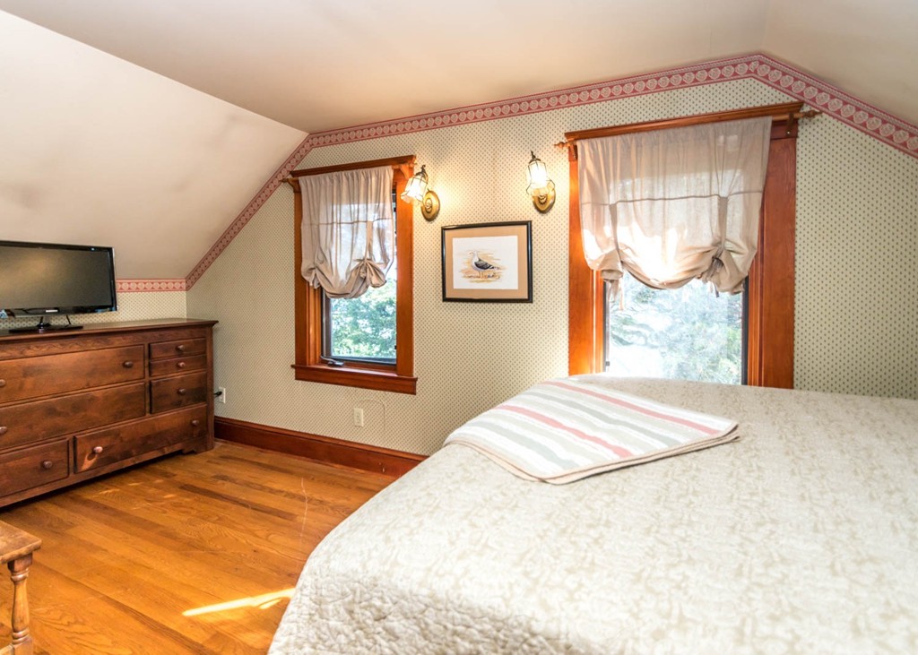 29 Virginia Road Waltham, MA 02453 - Photo 14 of 19 a bedroom with a bed and wooden floor
