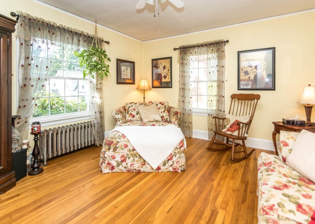 29 Virginia Road Waltham, MA 02453 - Photo 3 of 19 a bedroom with furniture and a wooden floor