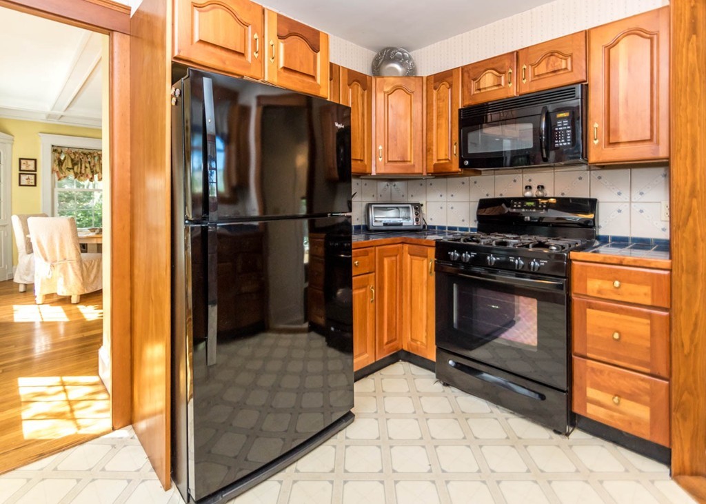 29 Virginia Road Waltham, MA 02453 - Photo 9 of 19 a kitchen with stainless steel appliances granite countertop a stove refrigerator and a microwave