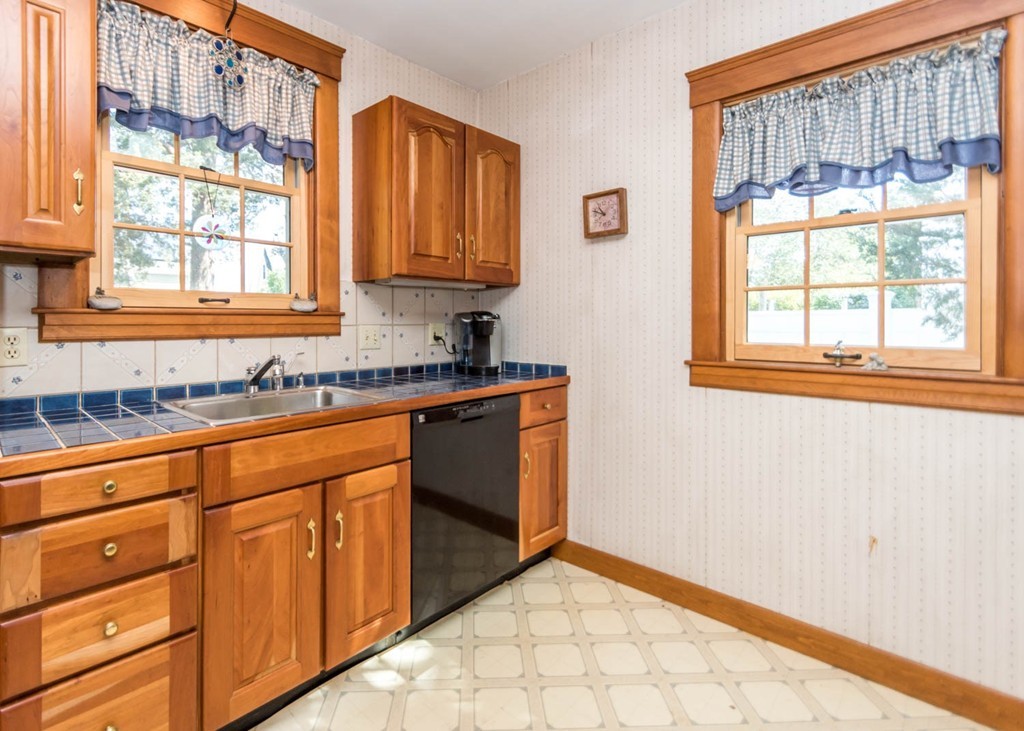 29 Virginia Road Waltham, MA 02453 - Photo 10 of 19 a kitchen with stainless steel appliances granite countertop a sink and a granite counter tops