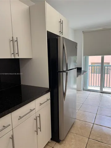 a white refrigerator freezer and a stove sitting inside of a kitchen