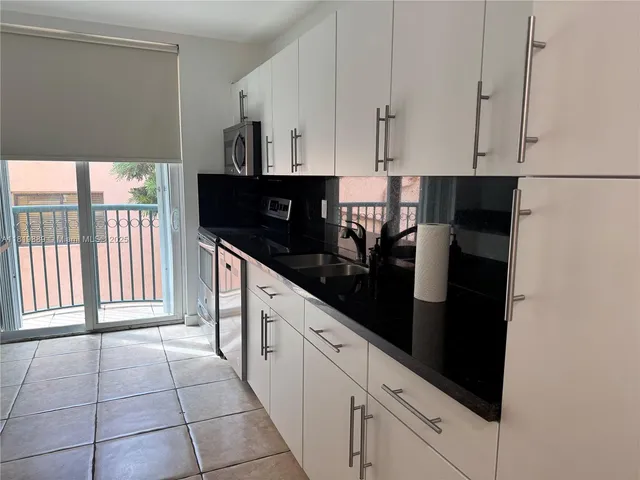 a kitchen with stainless steel appliances a sink and cabinets