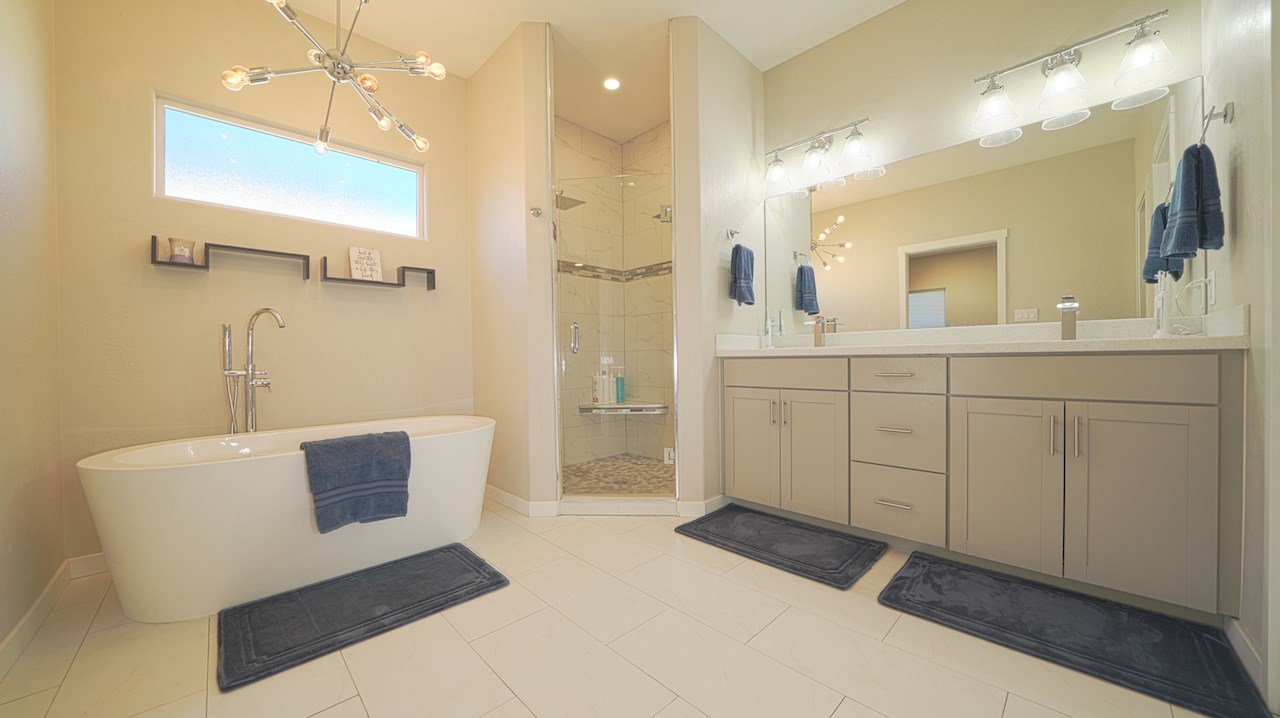 2476 Zenith Lane, Unit B Grand Junction, CO 81505 - Photo 12 of 24 a spacious bathroom with a double vanity sink a mirror and a shower