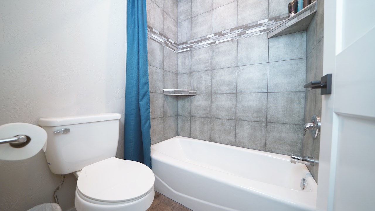 2476 Zenith Lane, Unit B Grand Junction, CO 81505 - Photo 18 of 24 a white toilet sitting next to a bathtub