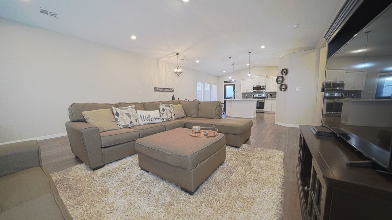 2476 Zenith Lane, Unit B Grand Junction, CO 81505 - Photo 3 of 24 a living room with furniture and a dining table with kitchen view