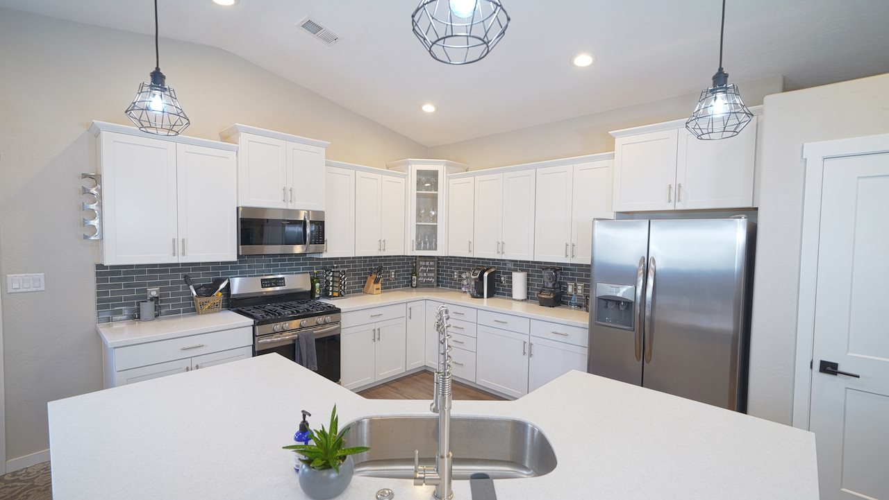 2476 Zenith Lane, Unit B Grand Junction, CO 81505 - Photo 7 of 24 a kitchen with stainless steel appliances a stove a refrigerator a sink and white cabinets