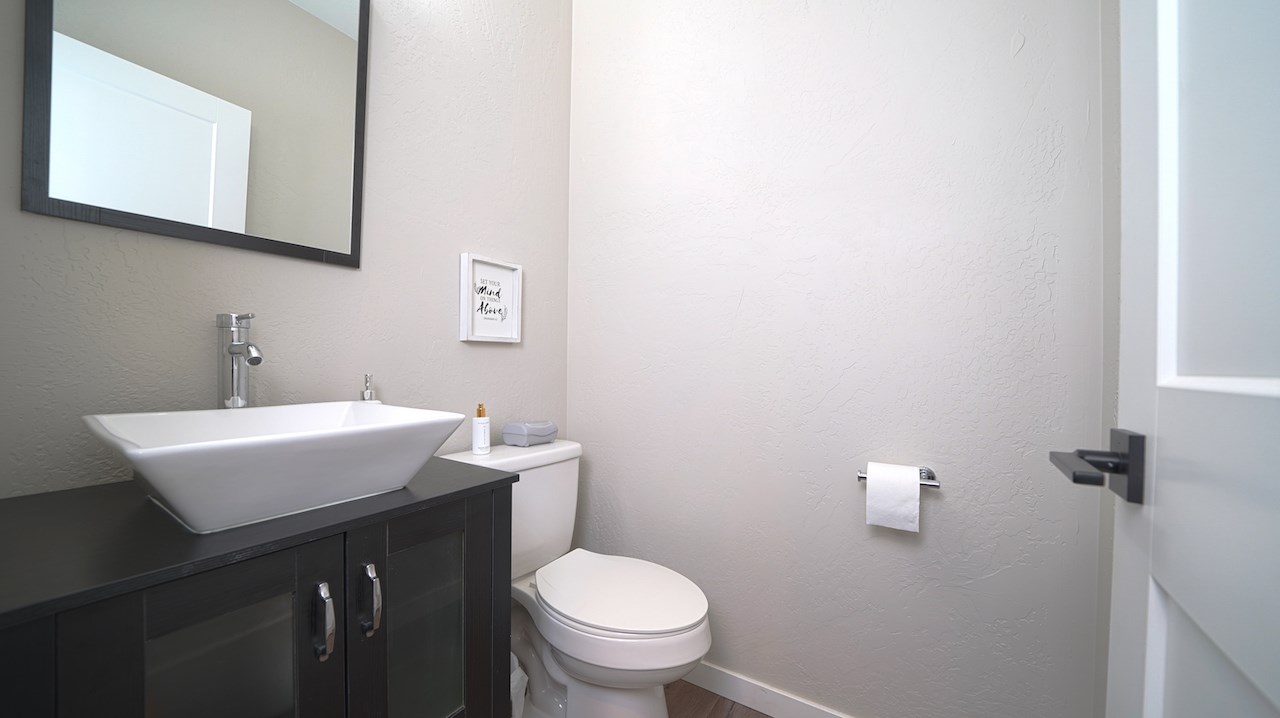 2476 Zenith Lane, Unit B Grand Junction, CO 81505 - Photo 8 of 24 a bathroom with a sink a toilet and mirror