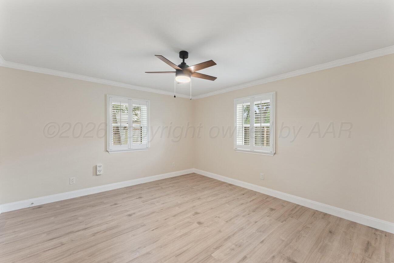 7204 Southwest 39th Avenue Amarillo, TX 79109 - Photo 38 of 51 a view of a room with wooden floor and a ceiling fan