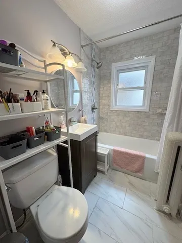 a bathroom with a sink a toilet and bathtub